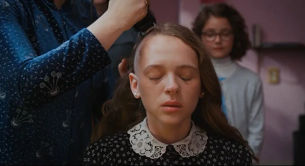 A haircut scene from Unorthodox, where a woman appears to have her hair trimmed.